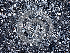 Gray pebbles as a background in the Iceland sea shore. Abstract composition.
