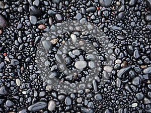 Gray pebbles as a background in the Iceland sea shore. Abstract composition.