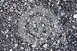 Gray pebbles as a background in the Iceland sea shore. Abstract composition.