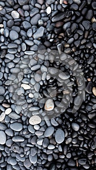 Gray pebbles as a background in the Iceland sea shore. Abstract composition