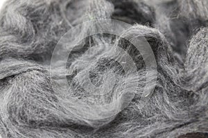 Gray piece of Australian sheep wool Merino breed close-up on a white background
