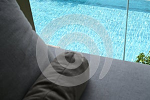 grey pillow put on bed, pool view