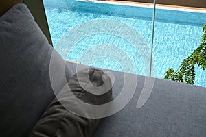grey pillow put on bed, pool view