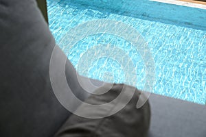 grey pillow put on bed, pool view