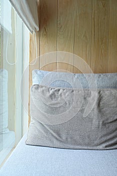 grey pillow put on bed in the room