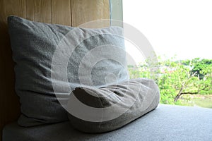 grey pillow put on bed in the room