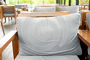 Gray pillow on wood chair