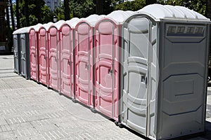 Gray and pink mobile bio toilets for men and women