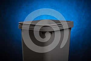 Gray plastic trash can