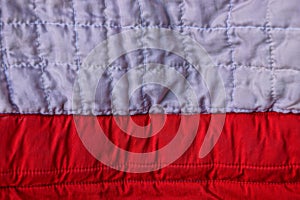 Gray red background fabric from the old piece of clothing with seams