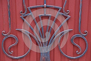 Gray red texture of iron forged rods in the pattern on the metal wall