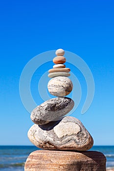 Gray and red zen stones on the background of the sea. Concept of harmony, balance and meditation