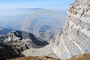 The gray rock on a background of a panorama of the mountains of Tien Shan