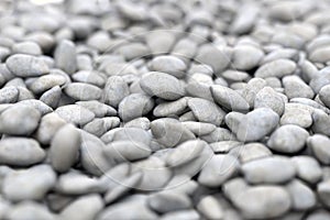 Gray rock pebbles beach on sea shore