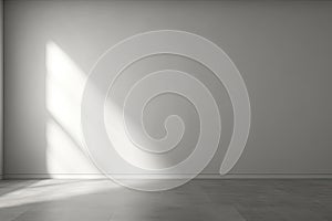 Gray room, concrete walls, light and shadow from the window directly on the wall. Empty room