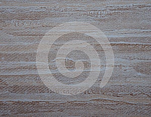 Gray sandstone, a flat surface of natural light stone with brown veins close-up