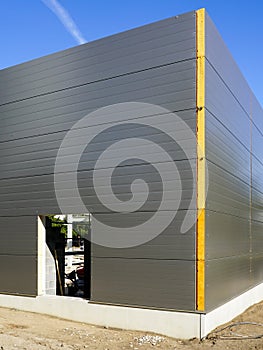 Gray sandwich panels facade of a new metal construction thermally insulated industrial building