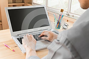 Gray Shirt Businessman Typing Laptop or Notebook in Home Office