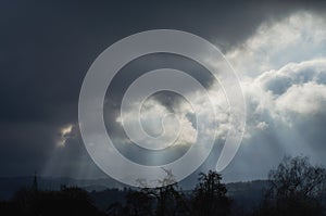 Gray sky before rain with rays of sun in Germany