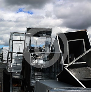Gray sky and silver metla boxes on landfill photo