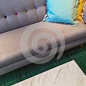 Gray sofa with blue and yellow cushions