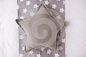 Gray star cushion mock up on a grey and white background with stars