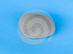 Gray stone isolated on blue background