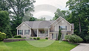 Gray Stone Split-level House in Wooded Setting