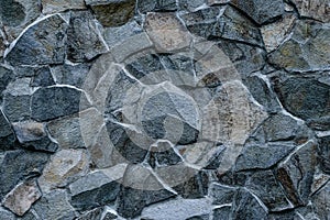 Gray stone wall background. Abstract rock texture. Modern style. Facade, building details. Mosaic of bricks. Grey grunge surface.