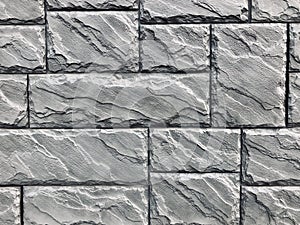 Gray stone wall, large brick masonry with seams