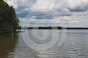 Gray storm clouds over the forest and lake. Pisochne ozero. Volyn region. Ukraine