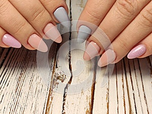 Gray striped nail design on female hand close up