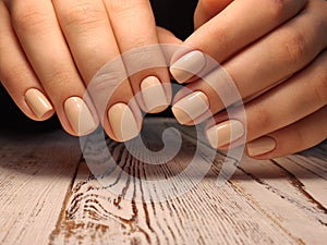 Gray striped nail design on female hand close up