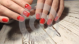 Gray striped nail design on female hand close up