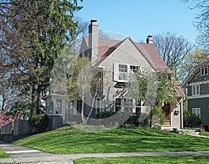 Gray Stucco House with Spring Trees & Flowers