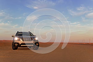 Gray Subaru in the sand of the Namib desert at a bright sky. Namibia