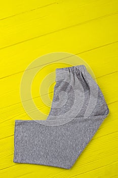 Gray sweatpants on yellow shelf