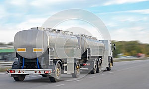 Gray tank truck driving on the highway