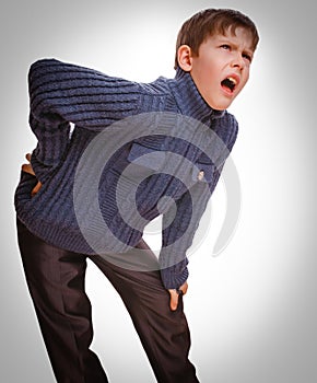 Gray teenage osteochondrosis boy holds teenager his hand behind photo