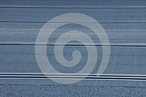 Gray texture of tram rails on asphalt