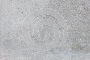 Gray textured cement wall background with fine concrete chips. Construction backgrounds