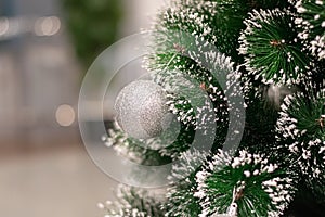 Gray toy green artificial christmas tree close-up