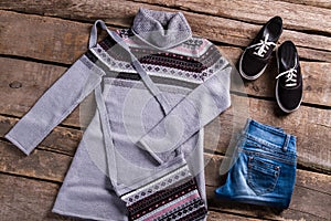Gray tunic with blue jeans.