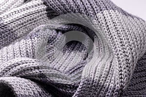 Gray two tone wool scarf background texture. Handmade product, closeup, selective focus
