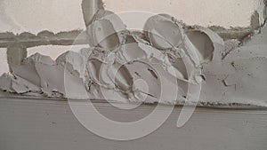 Gray wall of foam blocks on glutinous solution. Application of the solution to the wall from foam blocks