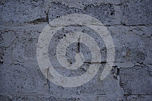 A gray wall of large blocks. Grey cinder block. The wall of an industrial building