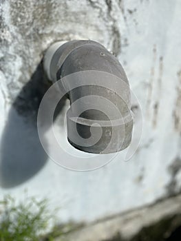 gray water drain pipe with a large hole