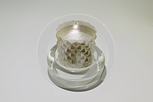 Gray wax candle in a glass base isolated