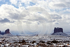 Gray Whiskers, left, and Mitchell, right, Buttes and the desert after a snowfall, Monument Valley photo