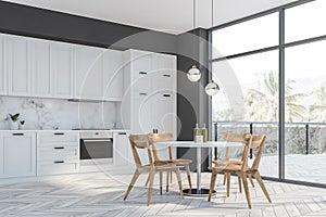 Gray and white kitchen corner, balcony and table